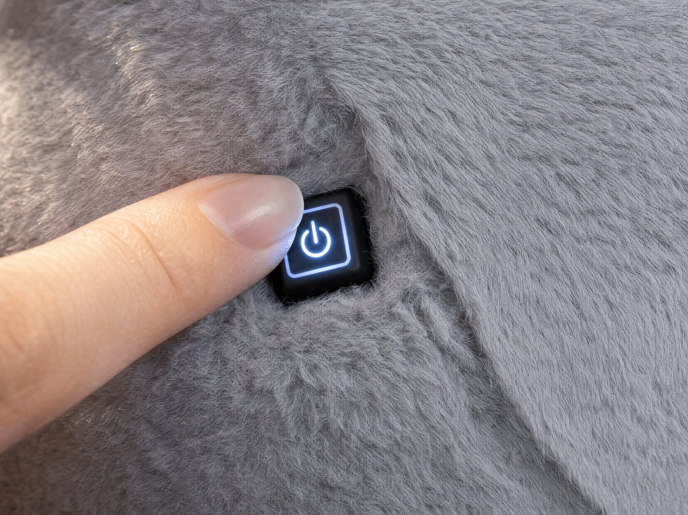 Fingertip resting on the touch control