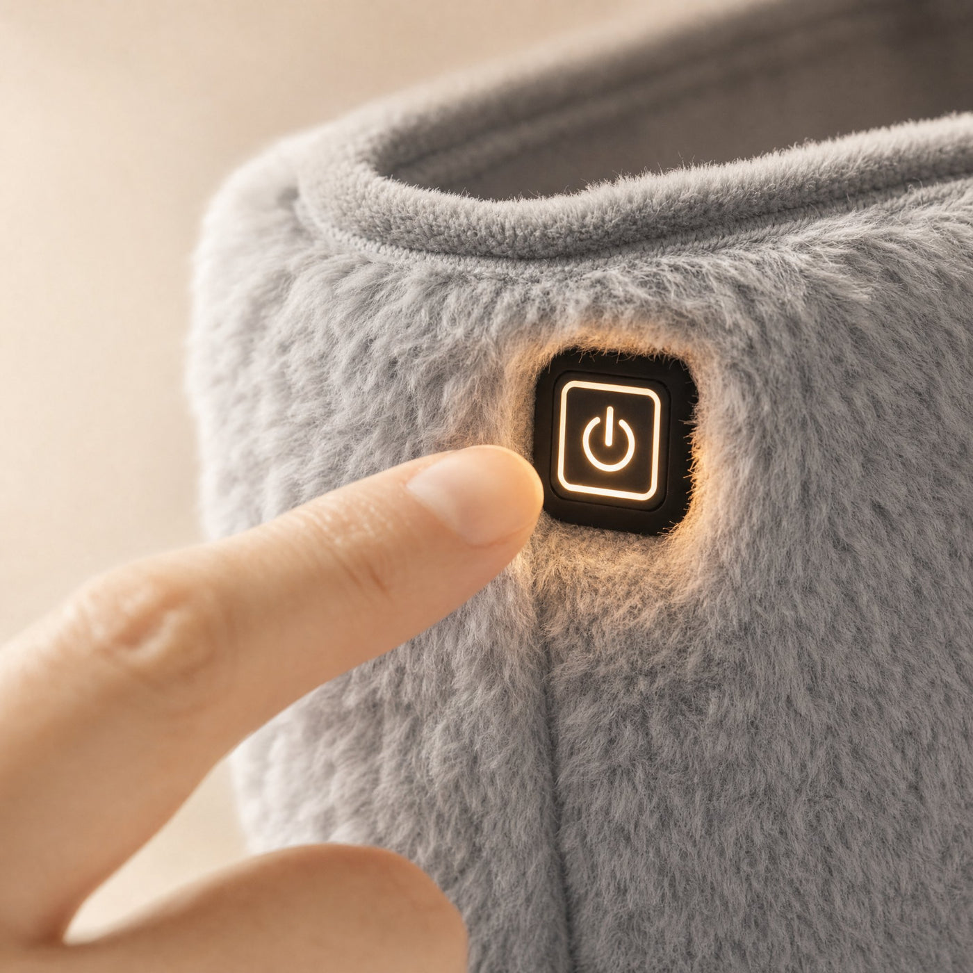 Close crop of the FuzzyPouch touch button glowing softly through the plush